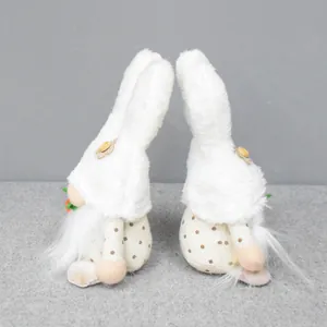 Detailed back view of two adorable white plush Easter bunny gnomes holding tiny carrots