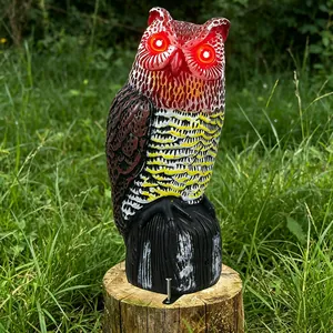 Solar powered owl garden decoy with glowing red eyes for outdoor courtyard decoration