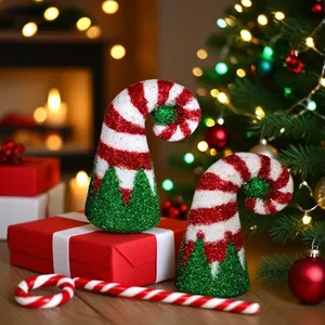 Close-up of two festive glitter elf hats with red and white stripes in Christmas scene.