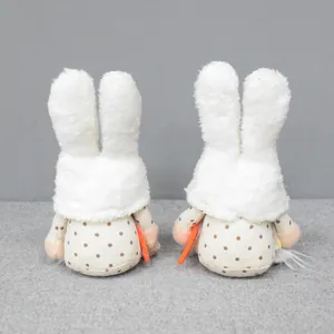Detailed back view of Easter plush rabbit gnomes with white fluffy ears holding carrots