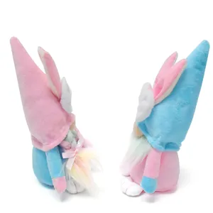 Side view of two cute Easter gnomes with bunny ears in pink and blue colors