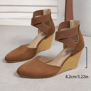 Elegant brown suede wedge sandals with cross ankle straps and 8.2cm heel height detail
