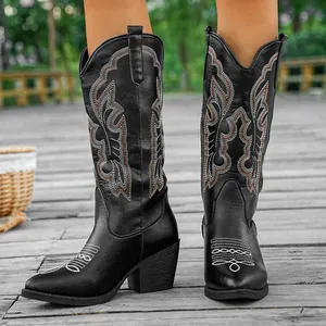 Detailed view of black vintage embroidered cowboy boots with block heels and V-cut