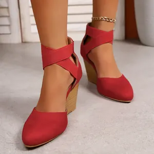 Detailed view of fashionable red pointed-toe wedge sandals with elastic cross ankle straps