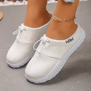 Close-up of women's white platform slip-on shoes with drawstring toggle detail