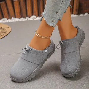 Close-up of women's comfortable gray suede wedge loafers with bungee toggle detail