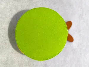 Top-down close-up of a green felt Easter rabbit basket showing stitched texture