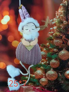 Detail of pink plush Christmas angel ornament with a gold glitter heart on a Xmas tree