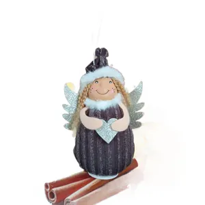 Adorable handmade plush Christmas angel girl ornament with silver wings and a glitter heart