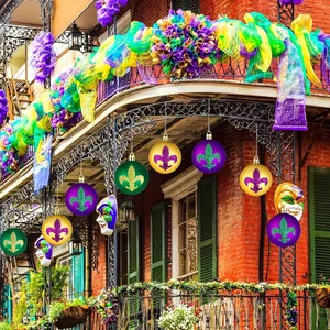 Detail of festive Mardi Gras ornaments with fleur-de-lis patterns hanging on a balcony