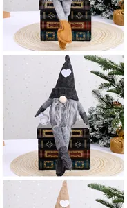 Handcrafted knitted faceless gnome sitting on decorative books for Christmas home decor