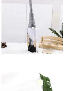 Detail view of gnome wine bottle cover with grey felt hat and white faux fur beard.