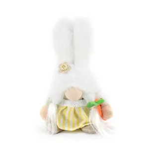 Close-up of a plush Easter bunny gnome holding a carrot featuring a yellow striped dress