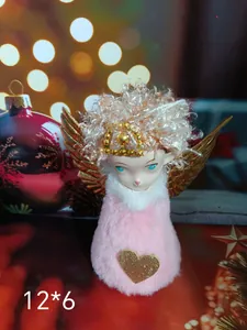 Detail view of a plush Christmas angel girl ornament featuring golden wings and heart.