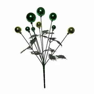 Close-up detail of decorative green metallic Christmas ball spray with silver holly leaves