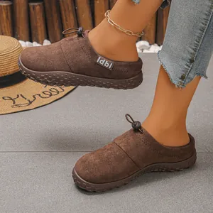 Macro view of stylish brown suede slip-on shoes with front drawstring and textured sole