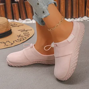Detailed view of fashionable pink suede slip-on shoes featuring adjustable toggle laces