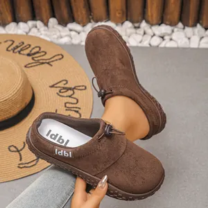 Detailed view of brown suede-like wedge shoes with drawstring lace and vintage design
