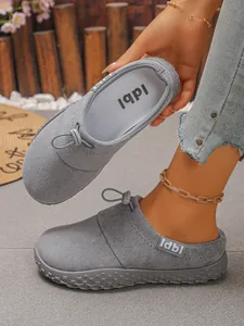 Macro detail showing the grey suede material and elastic drawstring on casual loafers.