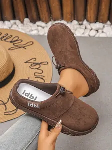 Close-up of retro brown suede-like lace-up comfort shoes for women