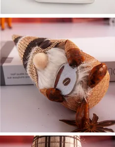 Close-up macro detail of a coffee-themed plush gnome with knitted hat and white beard