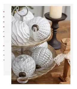 Detail of vintage white Christmas balls with silver glitter texture on a ceramic stand