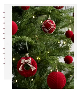 Detail shot of red flocked Christmas ball ornaments with festive patterns on a tree