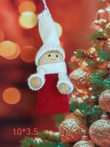 Detailed view of a handmade cloth angel girl Christmas tree ornament with a red dress