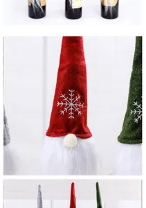 Close-up view of festive Christmas gnome wine bottle covers with embroidered snowflake hats