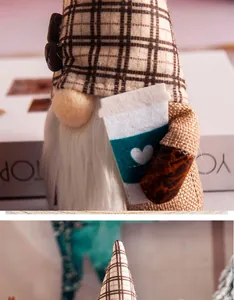 Close-up detail of a plush coffee gnome figurine with a plaid hat holding a cup.