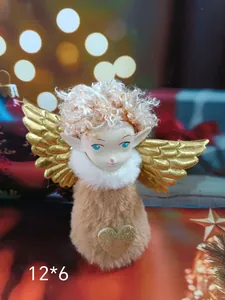 Close-up of a plush Christmas angel ornament with golden wings and a glittery heart