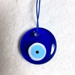 Macro detail of blue glass evil eye pendant with traditional Nazar pattern