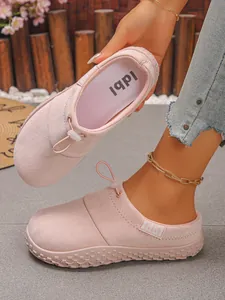 Close-up of pink suede slip-on clogs with front drawstring and anti-slip thick sole