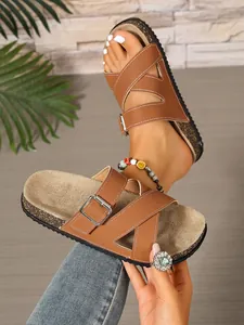 Detailed view of brown cross-strap cork sandals for outdoor beach and casual indoor wear