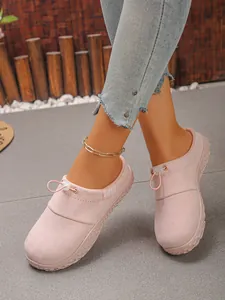 Detailed view of women's pink suede slip-on loafers featuring an adjustable drawstring cord