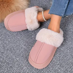 Detail view of pink fur-lined winter slippers shown on a gray textured carpet