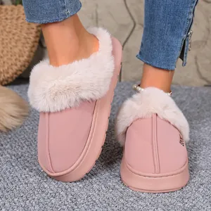 Detail view of pink winter slippers featuring plush fur lining and cozy textured sole
