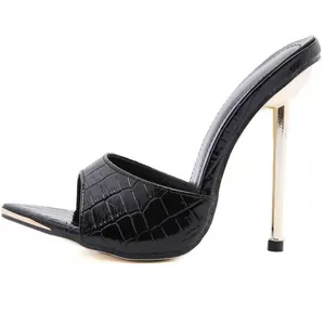 Detailed side view of black snake skin embossed texture on pointed toe high heel mules
