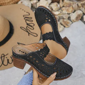 Detailed view of black hollow-out clogs with chunky wooden-style heels for summer.