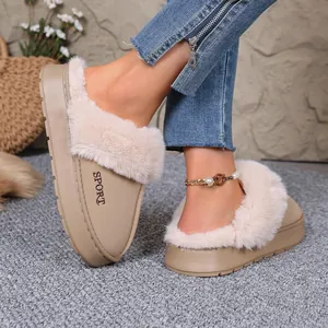Close-up of winter fur-trimmed slippers with "SPORT" logo detail in beige color