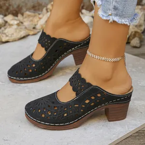 Women's black hollow-out closed-toe chunky heel mules with floral cutout pattern