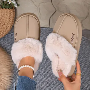 Close-up detail of winter beige slippers with plush fur lining and embroidery