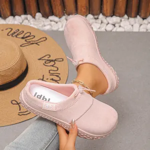 Detailed view of pink suede slip-on clogs featuring front toggle drawstring design