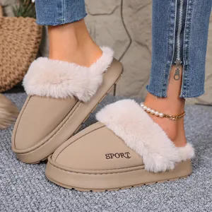 Close-up of warm winter slippers with fuzzy collar and SPORT text on khaki leather.