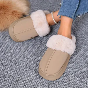 Cozy beige slippers with fluffy faux fur trim shown on a plush grey carpet background.