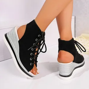 Detail view of ladies black lace-up platform wedge sandals with silver textured heels