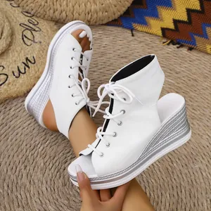 Detailed view of white open-toe wedge sandals with lace-up canvas sneaker style
