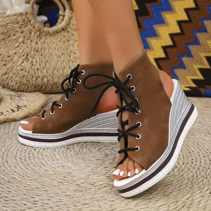 Detailed view of brown platform wedge sandals featuring front lace-up design and open-toe style