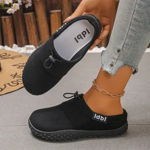 Stylish women's black suede slip-on clogs featuring drawstring detail and durable textured sole.