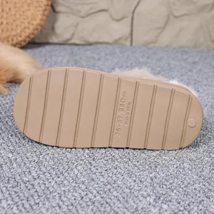 Macro detail of the anti-slip tan rubber sole on a plush winter indoor slipper for home